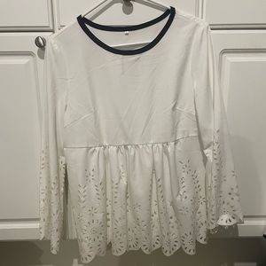 Women’s medium blouse with floral cut outs. Long sleeve with black trim